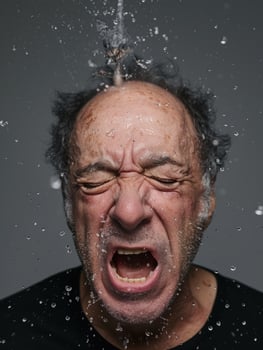 Intense expression of a mature man with water droplets photo