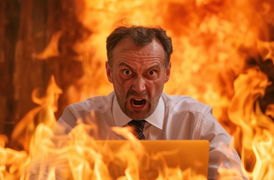 Angry businessman with fiery background photo