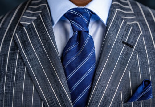Elegant business attire with striped suit and blue tie photo