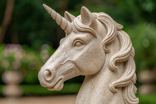 Decorative stone unicorn statue in garden photo