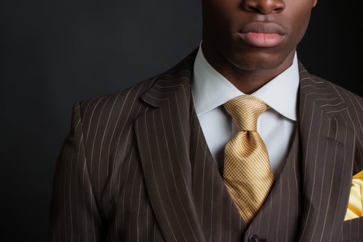 Confident businessman in a striped suit and gold tie photo