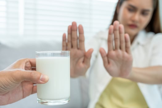 Milk allergens, Sick sad unhealthy ill allergic woman, runny stuffy sore nose suffer from intolerance allergy trigger symptoms. abdominal pain, allergens, nut protein, rash, death, food allergy photo
