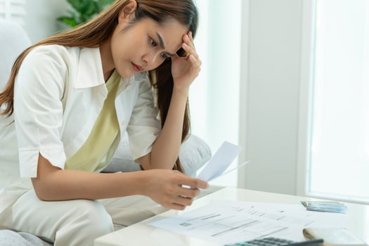 Stressed and headache asian woman with large bills or invoices no money to pay to expenses and credit card debt. shortage, Financial problems, mortgage, loan, bankruptcy, bankrupt, poor, empty wallet photo