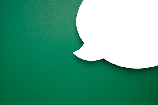 Blank white speech bubble part over a green background photo