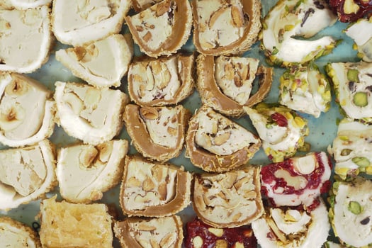 Assorted Colorful Turkish Delight Cubes on a White Plate photo