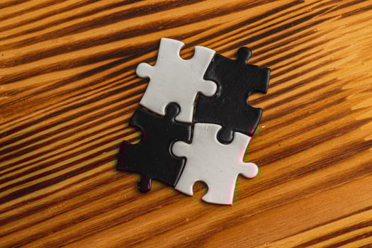 A black and white puzzle piece fit for a concept of yin yang or opposites photo