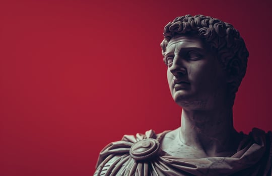 Dramatic ancient statue against red background photo