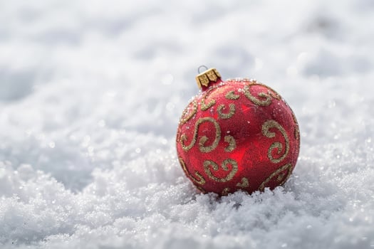 Festive red christmas ornament in snow photo