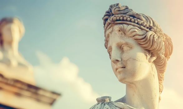 Serene ancient marble statue against blue sky photo