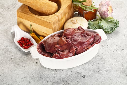 Raw uncooked chicken liver in the bowl photo