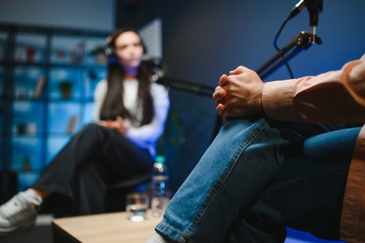 Show host interviewing woman during live stream, talking about fashion and style trends, disagreeing with her opinions. Man arguing with social media celebrity, recording podcast photo