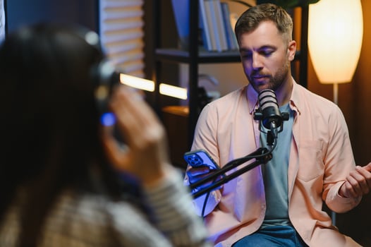 Show host interviewing woman during live stream, talking about fashion and style trends, disagreeing with her opinions. Man arguing with social media celebrity, recording podcast photo