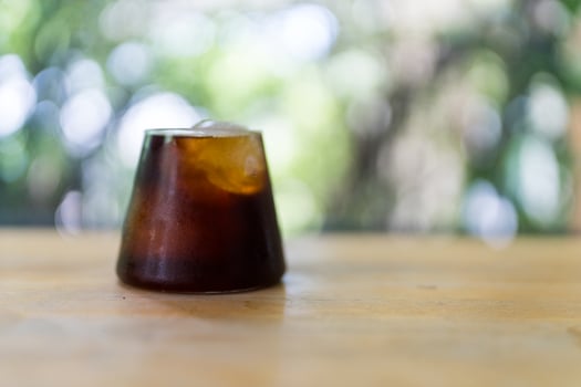 Close up of a black coffee with ice cubes in a clear glass photo