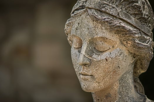 ancient stone sculpture face close up photo