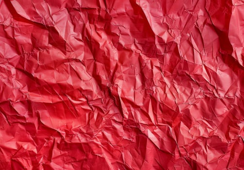 Crumpled red paper texture background photo