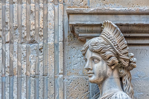 ancient stone sculpture of a woman with ornate headdress photo