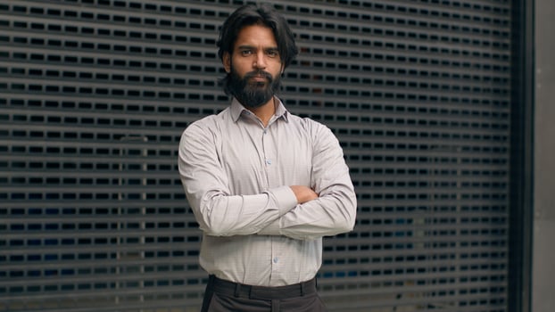 Serious concentrated confident successful bearded indian business man with glasses businessman employee manager salesman representative male entrepreneur guy assistant looking at camera posing indoors photo