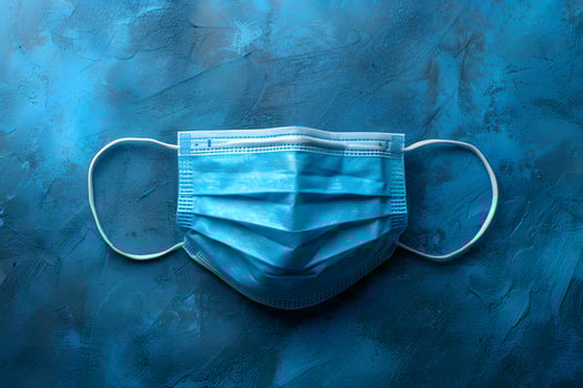 Blue Medical Face Mask on Textured Background Health and Safety Concept for Pandemic Awareness photo
