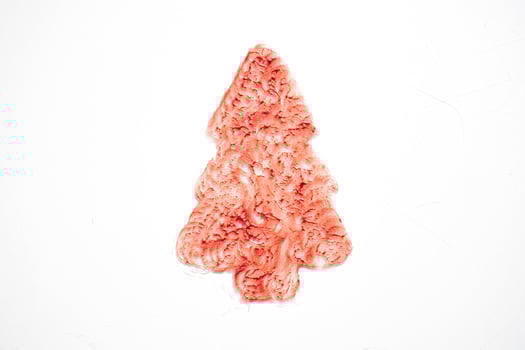 Sparkly red cream shaped like a Christmas tree on white background. Design element for cosmetic banner holiday sale photo