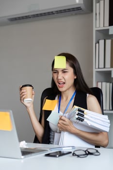 Focused Businesswoman Managing Work Documents in Modern Office Environment photo
