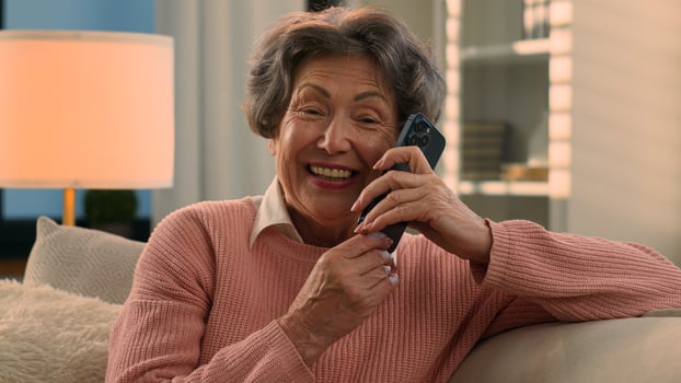 Happy laughing talking phone Caucasian old woman carefree senior lady listening funny news smile laugh retired grandma elderly female grandmother mobile conversation smartphone communication at home photo