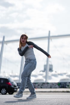 Young dancer showcases skills on urban street during daytime performance photo
