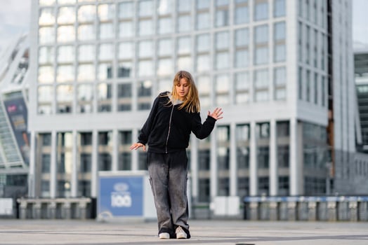 Dancer performs contemporary routine in urban setting during late afternoon photo