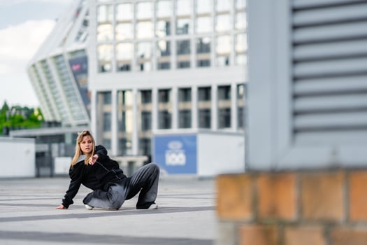 Young dancer showcases urban dance moves in a city environment photo