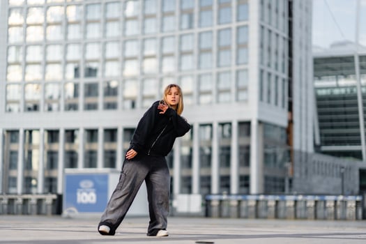 Young dancer performing in urban area during daytime photo