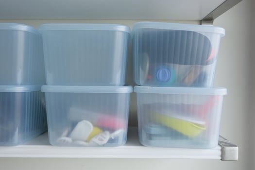 Organized Storage Bins Neatly Arranged on the Shelf for Various Office Supplies and Accessories photo