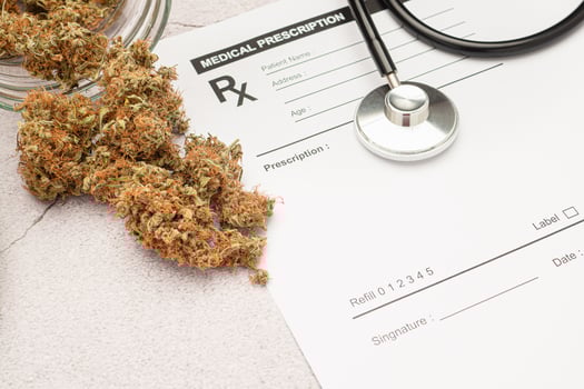 Dry marijuana buds flower and a stethoscope on the medical prescription sheet photo