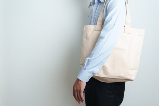 man with Eco Shopping tote bag with Copy space for text. Environmental Protection, Zero waste, Reusable, Say No Plastic, Sustainability, Eco Friendly, World Environment day and Earth day concept photo