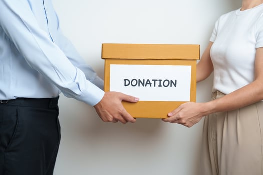 Donation, Charity, Volunteer, Giving and Delivery Concept. People donate Clothes and Food into Donation box at home or office for support and help poor, refugee and homeless people. Copy space photo