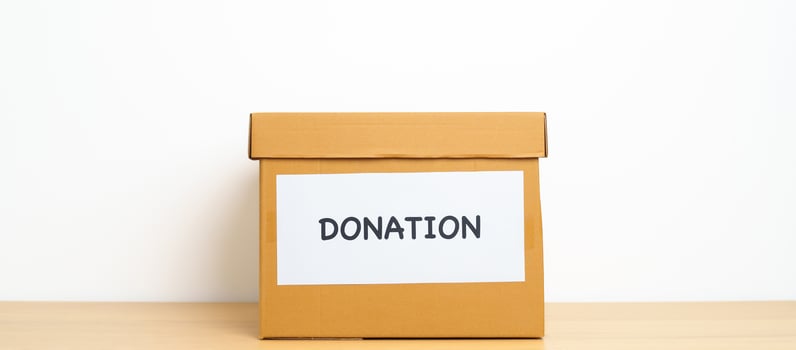 Donation, Charity, Volunteer, Giving and Delivery Concept. People donate Clothes and Food into Donation box at home or office for support and help poor, refugee and homeless people. Copy space photo