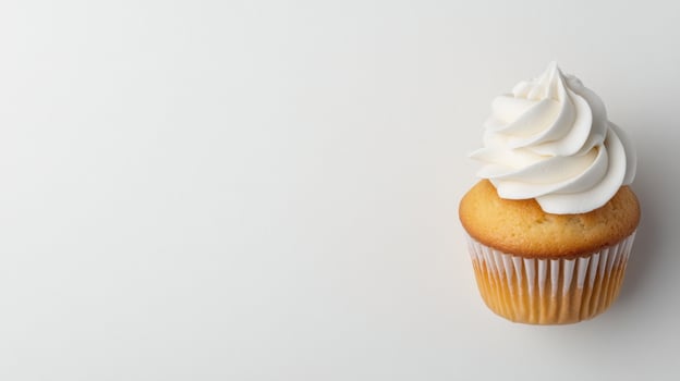 Delicious vanilla cupcake with creamy frosting on a plain background photo