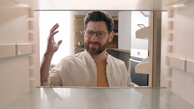 Point of view POV inside refrigerator Caucasian hungry sad angry frustrated man male guy unhappy disappointed with empty fridge unemployed crisis without products food delivery at domestic kitchen photo
