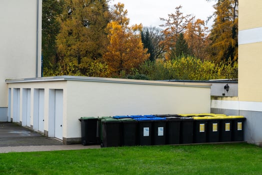 Waste collection area with recycling bins in a green space photo