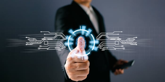 Businessman protecting personal data on finger print with virtual screen interfaces. Cyber security and privacy concepts to protect data. Lock icon and internet network security technology. photo