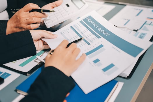 Business people working on financial documents photo
