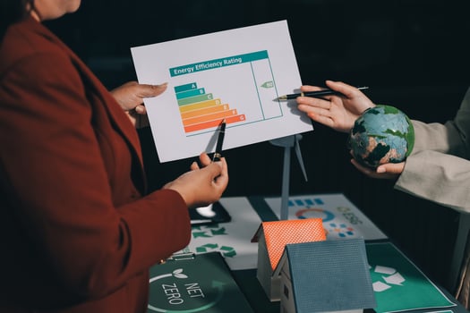 Two business people holding a paper with a graph on it photo