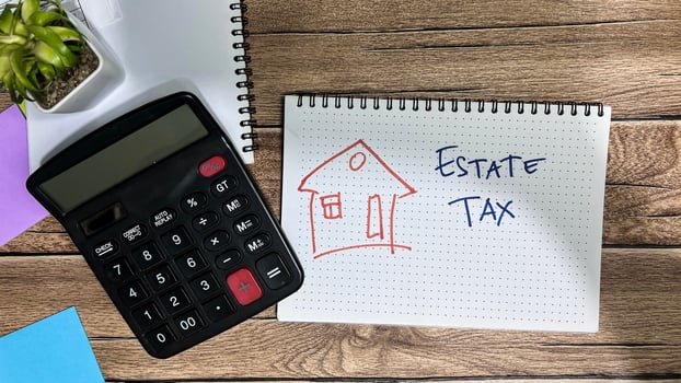 Concept of Estate Tax write on book isolated on Wooden Table. photo