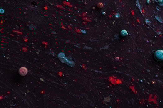 Amazing multi colored bubbles of paint on the oil surface. photo