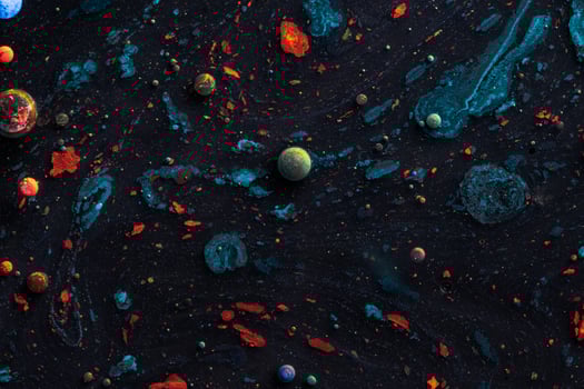 Amazing multi colored bubbles of paint on the oil surface. photo
