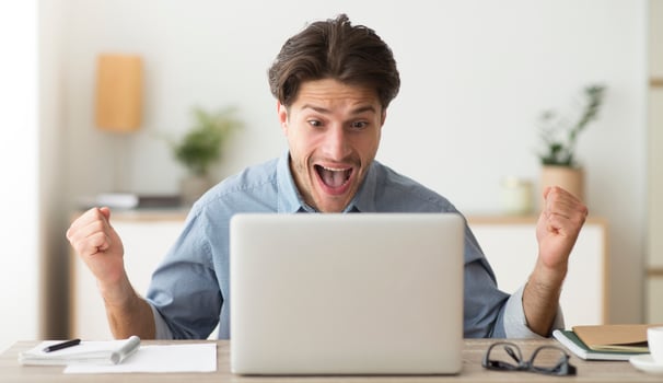 Luck And Win. Man Celebrating His Victory At Laptop Shaking Fists And Shouting Joyfully In Office photo