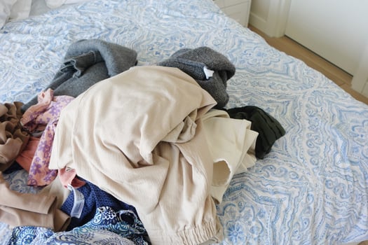 A Vibrant and Colorful Pile of Laundry Honestly Spread Out on a Cozy Bed in the Bedroom photo