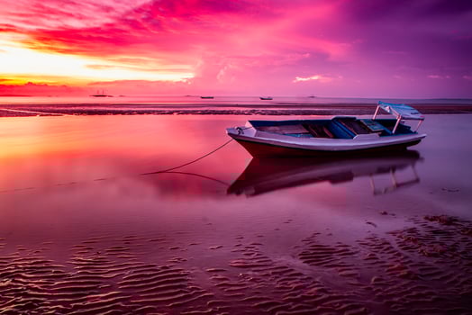 A Traditional Wooden Boat And Stunning Sunset at The Beach photo