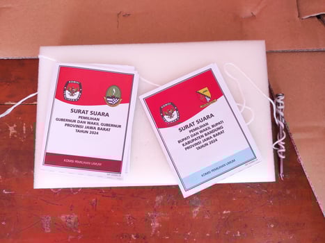 Cikancung, West Java, Indonesia - November 27, 2024. Ballot papers for the West Java Governor and Regent elections. Indonesian General Election. Regional Elections. Democracy and voting rights. photo
