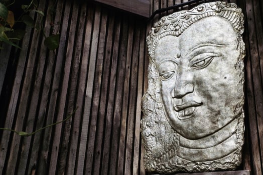 Close up Face of Avalokiteshvara Sculpture on Wall. photo