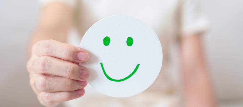 Woman show Happy Smile face paper, Mental health Assessment, Psychology, Health Wellness, Feedback, Customer Review, Experience, Satisfaction Survey, Positive Thinking and World Mental Health day photo