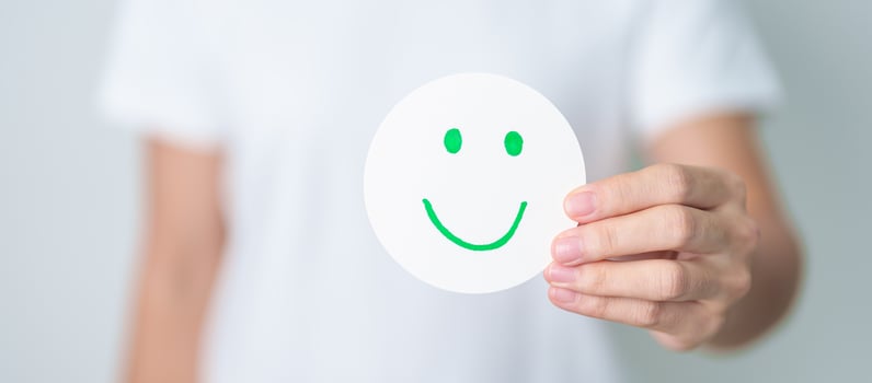Woman show Happy Smile face paper, Mental health Assessment, Psychology, Health Wellness, Feedback, Customer Review, Experience, Satisfaction Survey, Positive Thinking and World Mental Health day photo